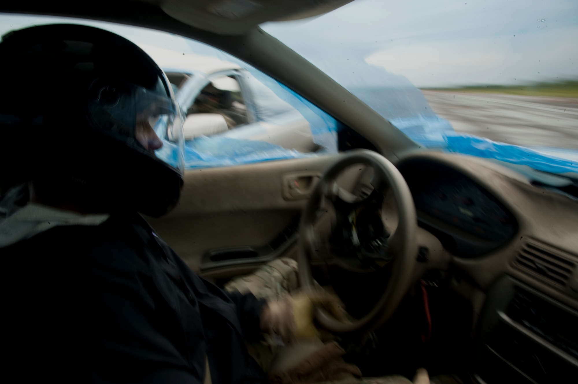 An instructor is hit with a Precision Immobilization Technique, better known as the PIT maneuver, during the Combat Aviation Advisor Military Qualification Skills Course defensive driving module on Eglin Range, Fla., June 19, 2013.  The instructors possess years of defensive driving experience, maintain all safety precautions and go through exhaustive safety briefings before initiating training. (U.S. Air Force photo by Airman 1st Class Benjamin Kim)