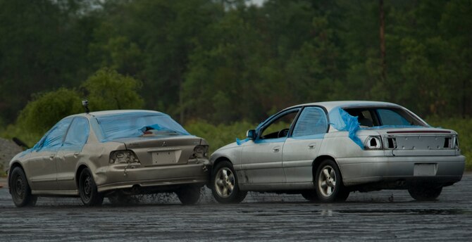 Airmen practice the Precision Immobilization Technique, better known as the PIT maneuver, during the Combat Aviation Advisor Military Qualification Skills Course defensive driving module on Eglin Range, Fla., June 19, 2013.  Airmen practiced chasing a car, driven by an instructor possessing years of driving experience, and utilizing the PIT maneuver to stop the vehicle. (U.S. Air Force photo by Airman 1st Class Benjamin Kim) 