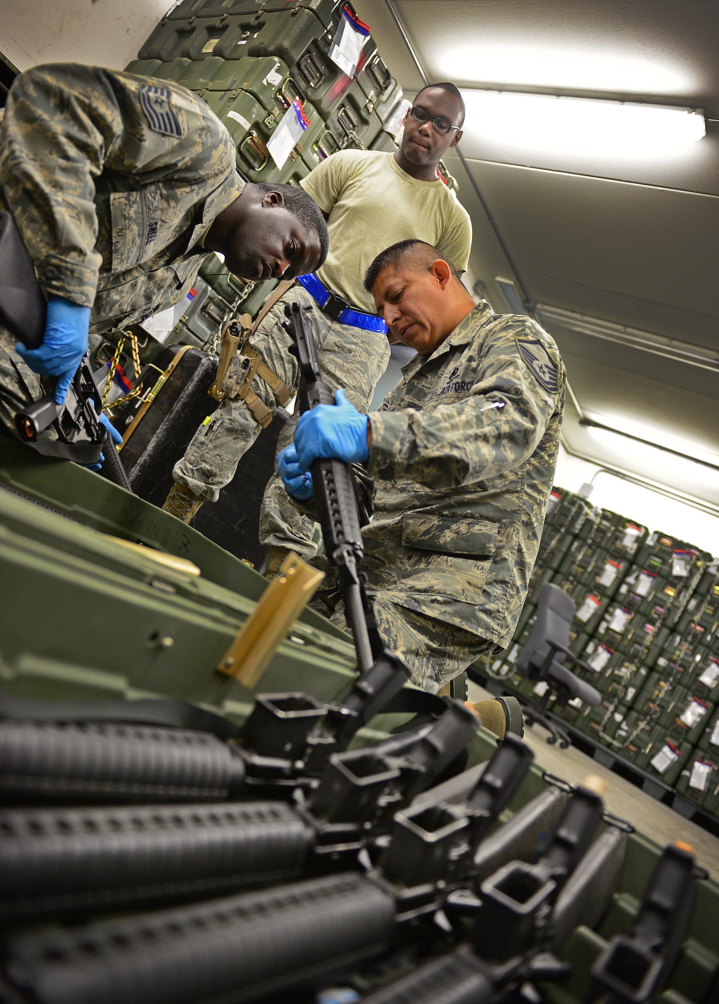 Tech Sgt. Glenn Snell and Master Sgt. Luis Rodriguez, 31st Logistics Readiness Squadron quality assurance evaluators, inspect a weapon, Aug. 8, 2013, at Aviano Air Base, Italy. Quality assurance evaluators are responsible for accurately inspecting the work of all LRS flights and reporting any discrepancies that should be resolved. McDonald is an individual equipment protection journeyman from the 31st LRS. (U.S. Air Force photo/Airman 1st Class Matthew Lotz)