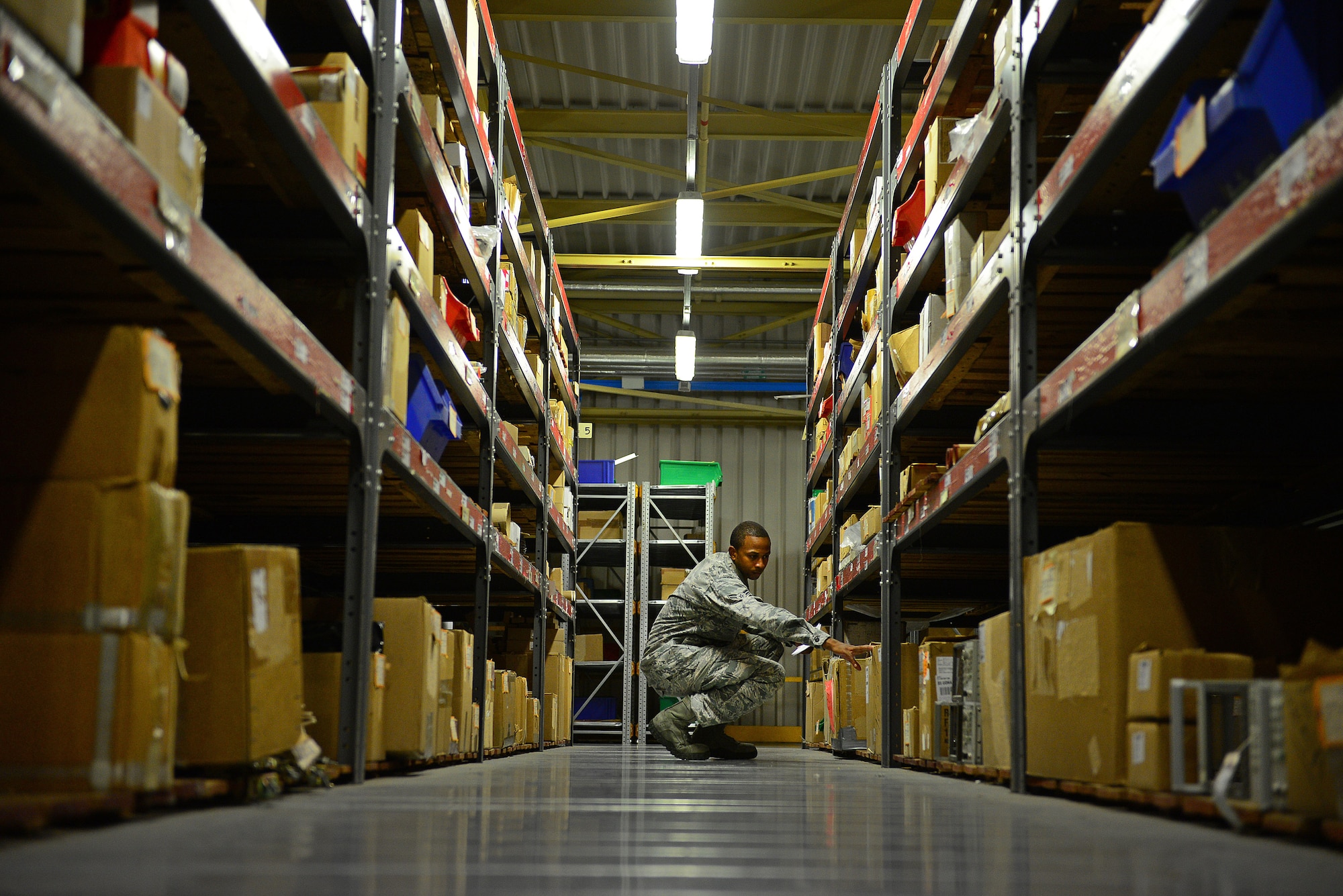 Airman 1st Class Marvin Peabody, 31st Logistics Readiness Squadron central storage journeyman, searches for a part, Aug. 7, 2013, at Aviano Air Base, Italy. The materiel management flight stores and catalogues all parts, broken or new, until they are ready to be properly disposed of or used. (U.S. Air Force photo/Airman 1st Class Matthew Lotz)