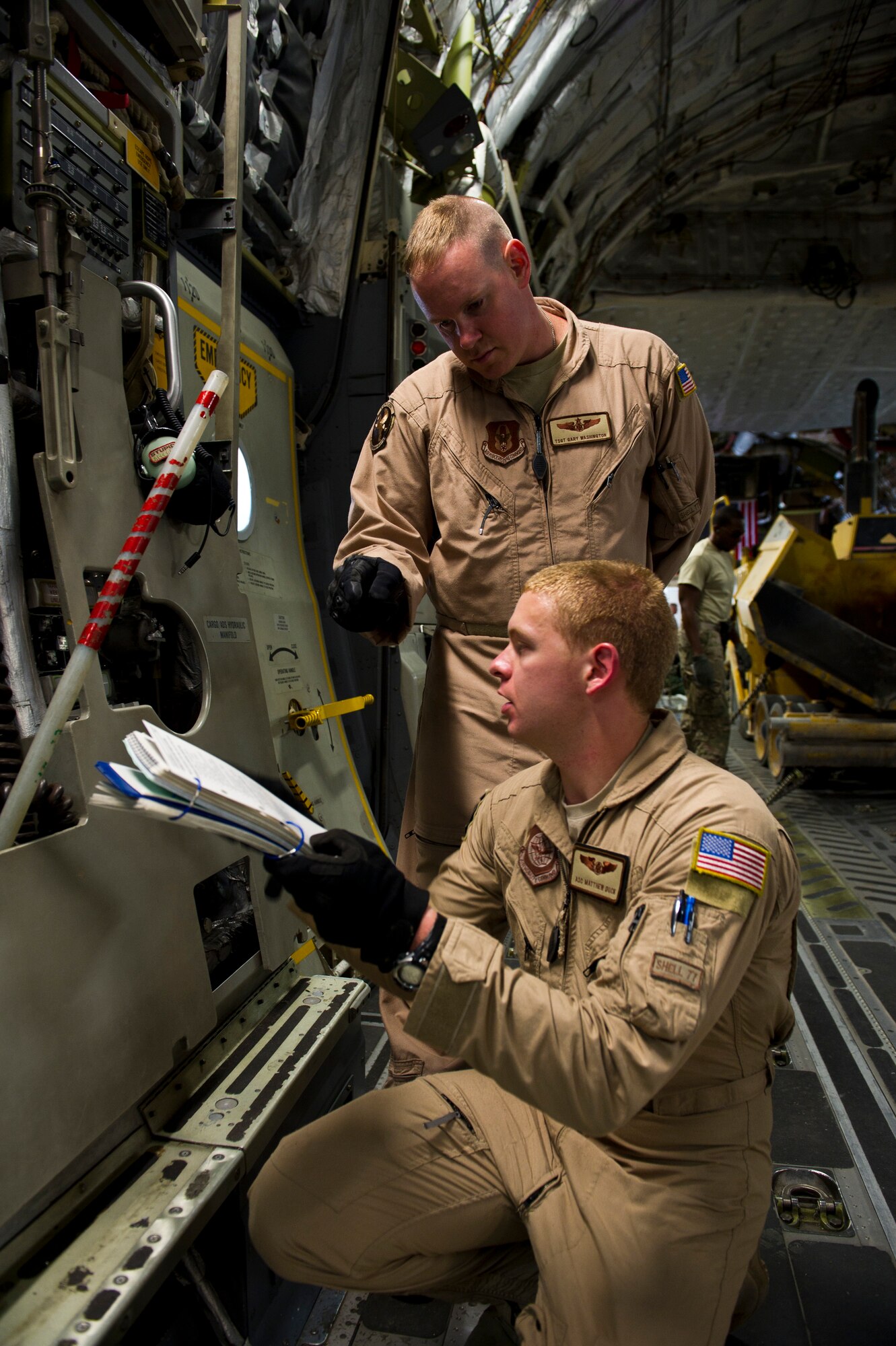 U.S. Air Force Tech. Sgt. Gary Washington, back, trains Airman 1st Class Matthew Duck, front, C-17 Globemaster III loadmasters assigned to the 316th Expeditionary Airlift Squadron, on the correct procedures to open the back of a C-17 Globemaster III before loading cargo during a mission, July 25, 2013, Bagram Air Base, Afghanistan. The C-17 is capable of rapid strategic and tactical delivery of troops and any type of cargo around the Central Command area of reasonability. The aircraft can perform airlift, airdrop, and transport ambulatory patients during aeromedical evacuations when required. (U.S. Air Force photo/Staff Sgt. Marleah Miller)