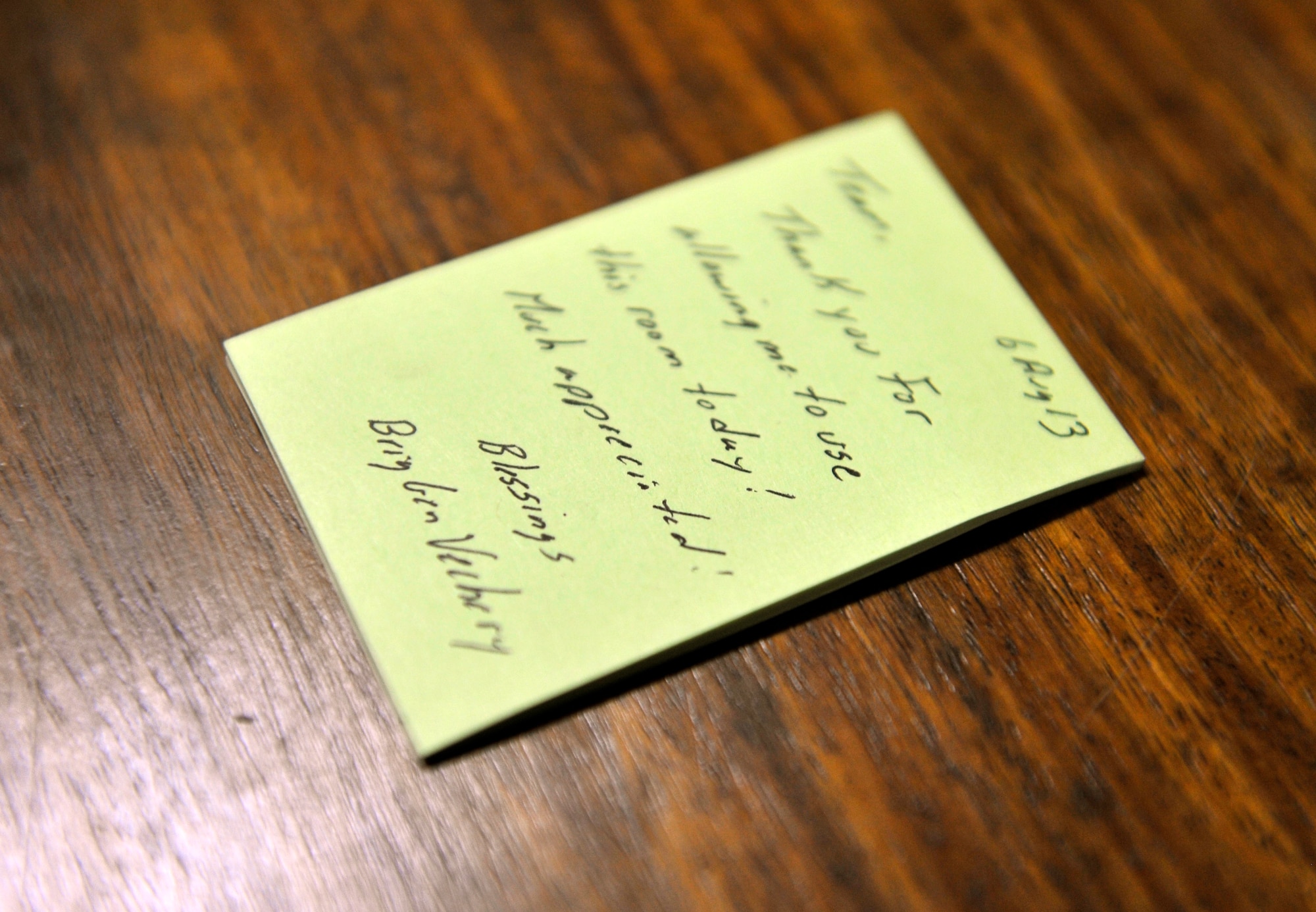 A distinguished visitor leaves a thank you note on the bed stand in a DV room on Bagram Airfield, Afghanistan, Aug. 8, 2013The 455th Air Expeditionary Wing Protocol office is in charge of maintaining all the DV lodging rooms here. (U.S. Air Force photo/Staff Sgt. Stephenie Wade)