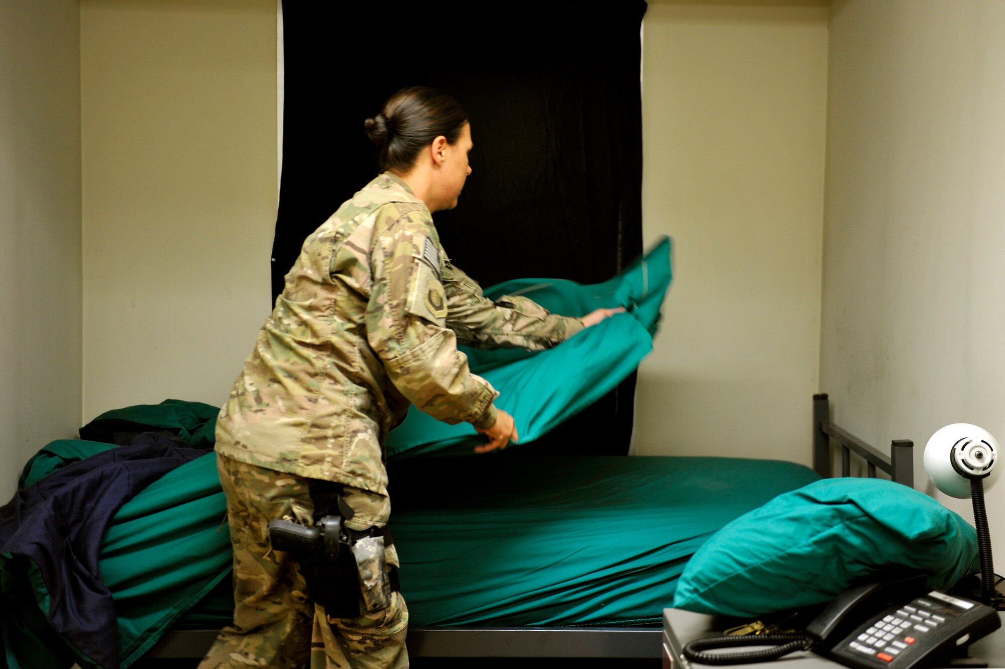 Staff Sgt. Amanda Harmon, 455th Air Expeditionary Wing NCO in charge of Protocol, makes the bed in a distinguished visitor’s room on Bagram Airfield, Afghanistan, Aug. 8, 2013.  Protocol is in charge of maintaining all the DV lodging rooms here.  She is deployed from Tyndall Air Force Base, Fla. (U.S. Air Force photo/Staff Sgt. Stephenie Wade)