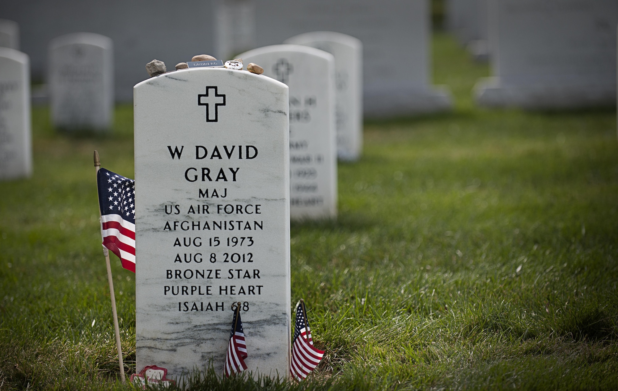 Tactical Air Control Party Airmen from the 13th Air Support Operations Squadron, Ft. Carson, Co., laid personal items on the headstone of Maj. David Gray, their fallen commander, who is laid to rest at Arlington National Cemetery, Aug. 8, 2013. Gray was killed in Afghanistan Aug. 8, 2012. The Airmen honored his memory by rucking more than 140-miles from Dover Air Force Base, Del. to Arlington National Cemetery to pay their respects at his gravesite. (U.S. Air Force photo/Senior Airman Lauren Main) 