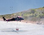 Air crews with the California Army National Guard draw water from a local lake during training on wildfire response operations with local and state fire officials. Members of the National Guard continue to train with local, state and federal authorities in order to stay prepared for response to potential hurricanes, tornados, wildfires and other disaster and emergency situations. In 2012 Guard members responded to more than 100 such situations, including wildfires in western states and Hurricane Sandy along the East Coast.