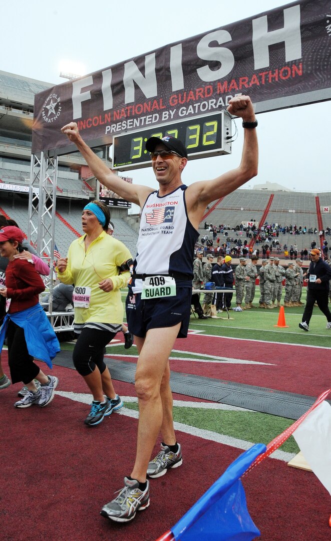 Senior Master Sgt. Michael White of the Washington Air National Guard triumphantly crosses the finish line of the 36th Annual Lincoln National Guard Marathon on May 5, 2013. White was one of more than 200 National Guard runners from 44 states and two territories who joined nearly 10,000 runners for the annual race.