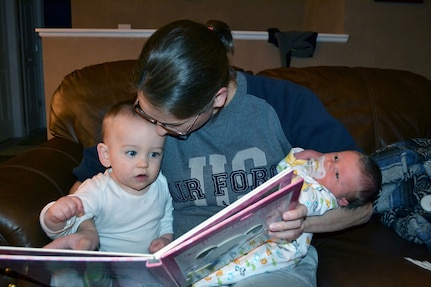 Kathryn Western, wife of Maj. Michael Western of the 128th Air Control Squadron, cradles her two children, Owen, 1, and newborn Jaxson, who was born Jan. 25. The Westerns were one of seven families in the 128th that had a child or are expecting one during the unit's deployment to the Middle East.