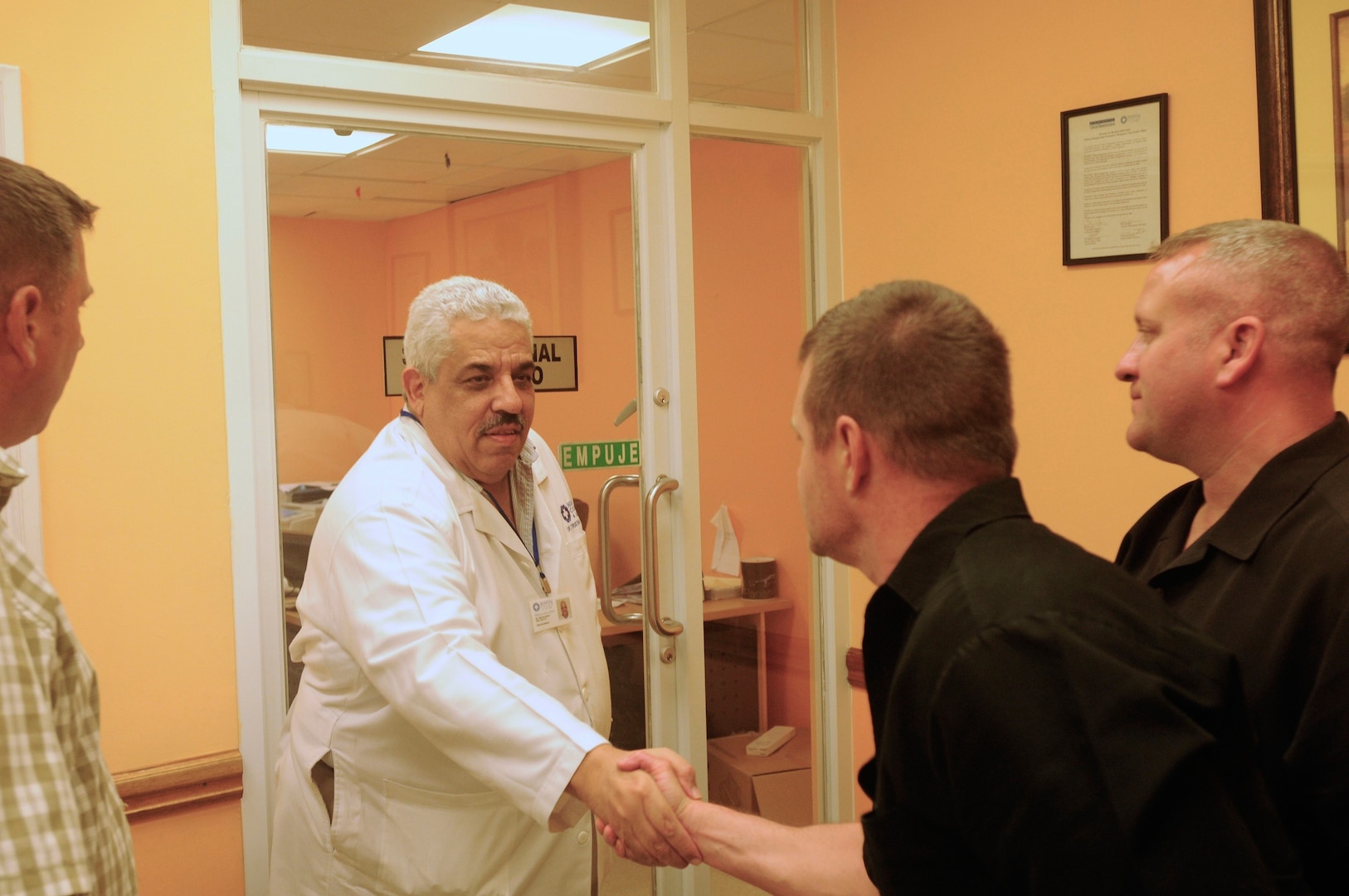 Maj. Dan Winschel, center, and Capt. David Donth, right) Rhode Island National Guard, meet with Dr. Tristan Pinzon, director of Hospital Colon, to tour the facility and meet the Panamanian staff.