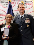 Alicia Hinds Ward accepts the 2013 Military Spouse of the Year award alongside Lt. Gen. Stanley E. Clarke III, the director of the Air National Guard.