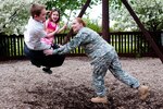 Sgt. 1st Class Sarah J. Campbell pushes her children, Austin and Kiana, on a tire swing at the Rochester Community Park May 6, 2013. Campbell was reunited with her children in March, after serving for nine months in Kuwait.