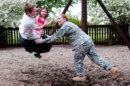 Sgt. 1st Class Sarah J. Campbell pushes her children, Austin and Kiana, on a tire swing at the Rochester Community Park May 6, 2013. Campbell was reunited with her children in March, after serving for nine months in Kuwait.