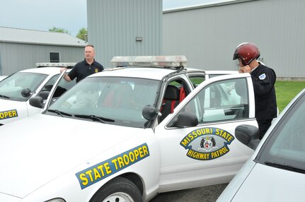 Costa Rica National Police Officer Francisco Vargas prepares for the Missouri Highway Patrol driving course as part of a Missouri National Guard State Partnership Program event May 8, 2013. Guiding Vargas through the course is Missouri State Trooper Bruce Baker and Air National Guard 1st Lt. Todd Cantwell who served as the interpreter.