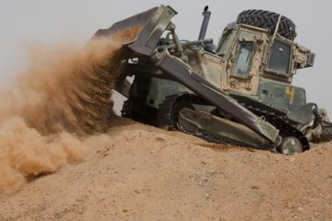 U.S. Marine Pfc. Michael Richardson, a heavy equipment operator with Engineer Company, Combat Logistics Regiment 2, Regional Command (Southwest), operates a 850JR John Deere Dozer at Camp Dwyer, Helmand province, Afghanistan, Aug. 7, 2013. Richardson collected dirt to assist in area improvements at the Camp. (U.S. Marine Corps photo by Sgt. Anthony L. Ortiz / Released)

