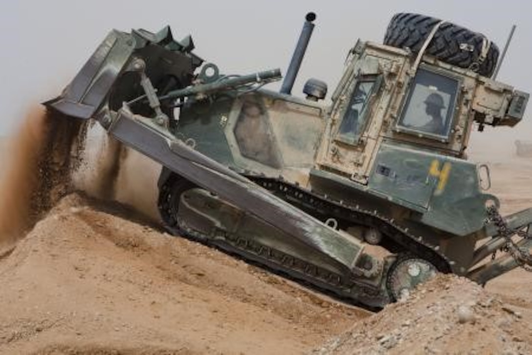 U.S. Marine Pfc. Michael Richardson, a heavy equipment operator with Engineer Company, Combat Logistics Regiment 2, Regional Command (Southwest), operates a 850JR John Deere Dozer at Camp Dwyer, Helmand province, Afghanistan, Aug. 7, 2013. Richardson collected dirt to assist in area improvements at the Camp. (U.S. Marine Corps photo by Sgt. Anthony L. Ortiz / Released)

