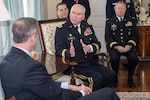 Maj. Gen. James A. Adkins, adjutant general of Maryland, discusses the Maryland National Guard's State Partnership Program with Gov. Martin O'Malley during a reception for senior delegations from the two nations on May 13. At right is Gen. Frank Grass, chief of the National Guard Bureau.