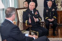 Maj. Gen. James A. Adkins, adjutant general of Maryland, discusses the Maryland National Guard's State Partnership Program with Gov. Martin O'Malley during a reception for senior delegations from the two nations on May 13. At right is Gen. Frank Grass, chief of the National Guard Bureau.