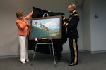 U.S. Rep. Madeline Bordallo, left, of Guam, and Army Brig. Gen. Walter E. Fountain, acting deputy director of the Army National Guard, unveil the newest National Guard Heritage Painting "Tragedy in Paradise—The Recovery of Flight 801" during the celebrations of Asian-American and Pacific Islander Heritage Month at the Army National Guard Readiness Center in Arlington, Va., May 16, 2013.