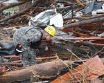 Sgt. Warren Williams of the 63rd Civil Support Team searches debris in Moore, Okla., in response to the May 20, 2013, EF-5 tornado.