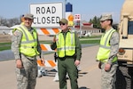 U.S. Customs and Border Patrol agent Collin Blackwell, center, discusses tactics with U.S. Army Soldiers, from left to right, Spc. Brandon Nelson and Spc. Fredrick Burdick, both of the 3662nd Maintenance Company, North Dakota Army National Guard, at a traffic control point on the outskirts of Cavalier, N.D.