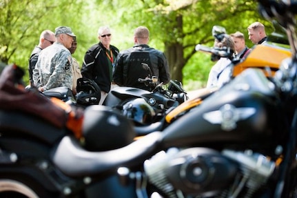 Participants in a motorcycle safety ride from the Marine Corps War Memorial just outside of Joint Base Myer-Henderson Hall to the National Museum of the Marine Corps gather around Lt. Devon H Foster, chaplain, to bless the bikes and start the ride with a prayer, May 3, 2013. Both Marines and Soldiers took part in the ride.