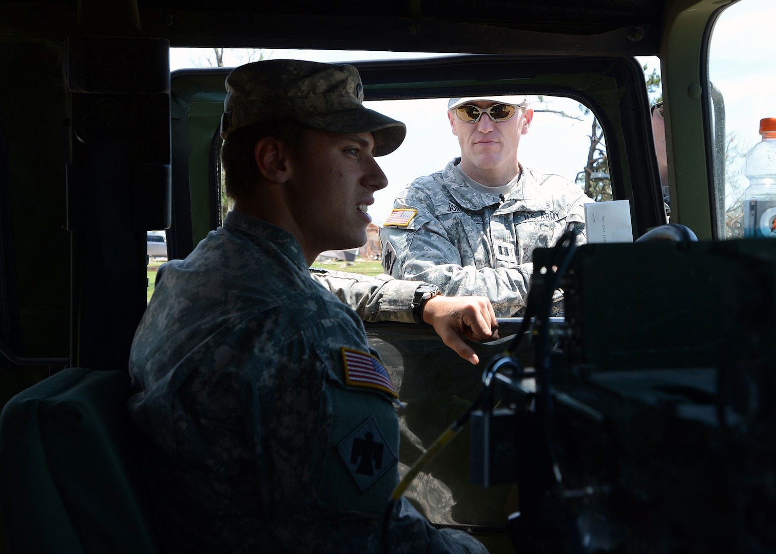 Spc. James Kimball, Headquarters and Headquarters Company, conveys to Chaplain Capt. David Jordan, Company A, 1st Battalion, 279th Infantry Battalion, on May 22, 2013, that he grew up in the tornado-torn area of Moore, Okla.