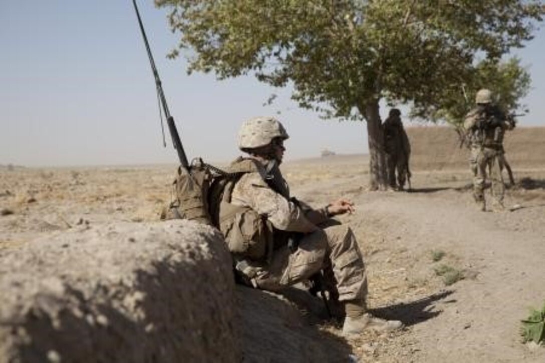 U.S. Marine Corps Cpl. William Ahern, a radio operator with Georgian Liaison Team 9, rests during a patrol in Mohammad Abad, Helmand province, Afghanistan, July 23, 2013. Coalition forces conducted patrols to gather human intelligence and disrupt future enemy activity. (U.S. Marine Corps photo by Cpl. Geoffrey K. Scarborough/Released)


