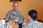 Chief Warrant Officer 5 Thomas Ensminger, command chief warrant officer of the Army National Guard Bureau, meets with Warrant Officer Tracy Rosa, Warrant Officer Basic Course student, 260th Military Battalion, Florida ARNG, to discuss warrant officer needs and recruitment.