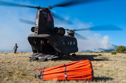 Colorado Army National Guard Sgt. Nicholas Parrott, flight engineer, ensures his CH-47 Chinook helicopter is ready for flight as the helicopter and crew prepare to fight the East Peak fire burning in Huerfano County, Colo., June 21, 2013.