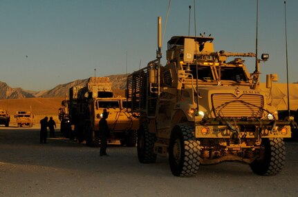 Soldiers assigned to the 3rd Platoon, 1245th Transportation Company, 1034th Combat Sustainment Support Battalion, escort military vehicles in preparation for a convoy escort team mission en route to two forward operating bases in the Regional Command North, at Mazar-e-Sharif, Balkh province, Afghanistan, June 18, 2013.