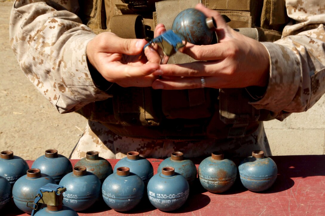 M69 practice grenades are assembled during Marine Air Support Squadron 3 of 3rd Marine Aircraft Wing here live-fire grenade training at Range 109 here Aug. 13. The 24 Marines from the support squadron also conducted live-fire training with M67 Fragmentation Grenades.
