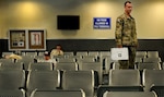 Senior Airman David Kitchen holds a first aid kit he has used many times when aiding passengers at Bagram Air Field, Afghanistan.