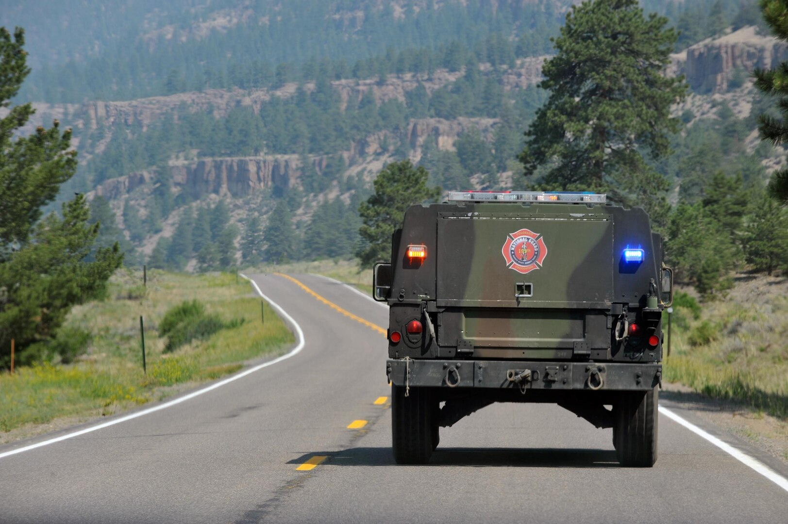 A Humvee with members of the 1157th Engineer Firefighting Company travels down Colorado Highway 149 in Rio Grande County Colo., June 25, 2013.