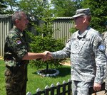 U.S. Army Lt. Col. Joseph Grimmett, the Joint Implementation Commission Chief and a member of the Utah National Guard, greets his Serbian Armed Forces counterpart after a coordination meeting in Vrapce on June 21. The two groups meet monthly to coordinate their efforts along the Administrative Boundary Line between Kosovo and Serbia.