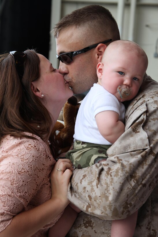 Cpl. Nicholas Carr, an ejection seat mechanic with Marine Tactical Electronic Warfare Squadron 4, embraces his family Aug. 7 after returning from a six-month deployment to Iwakuni, Japan. 