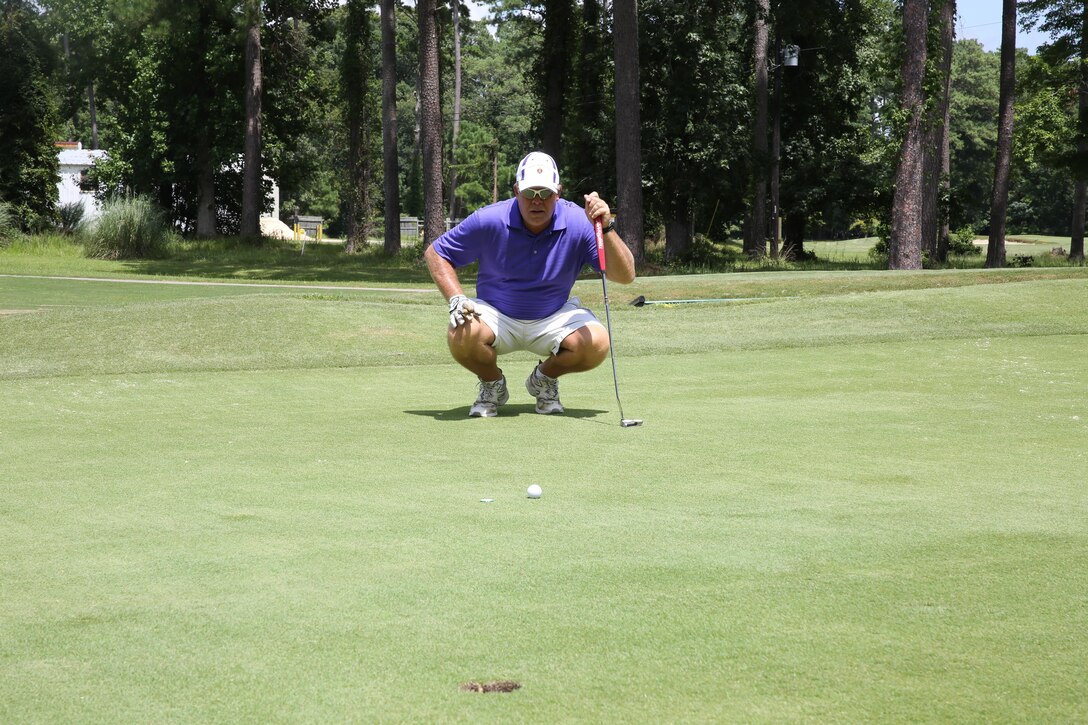 Marshel Patterson, a retired gunnery sergeant, lines up his shot during the Sergeants Major Golf Tournament Friday. 
