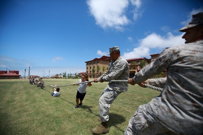 Marines and sailors serving with 1st Light Armored Reconnaissance Battalion play a game of tug of war with their children during the battalion's Bring Your Kids to Work Day at Camp Las Flores here, Aug. 9, 2013. Highlanders, the battalion's nickname, allowed the children to tour light armored vehicle variants, shoot weapons at the battalion's Indoor Simulated Marksmanship Trainer and participate in field games.