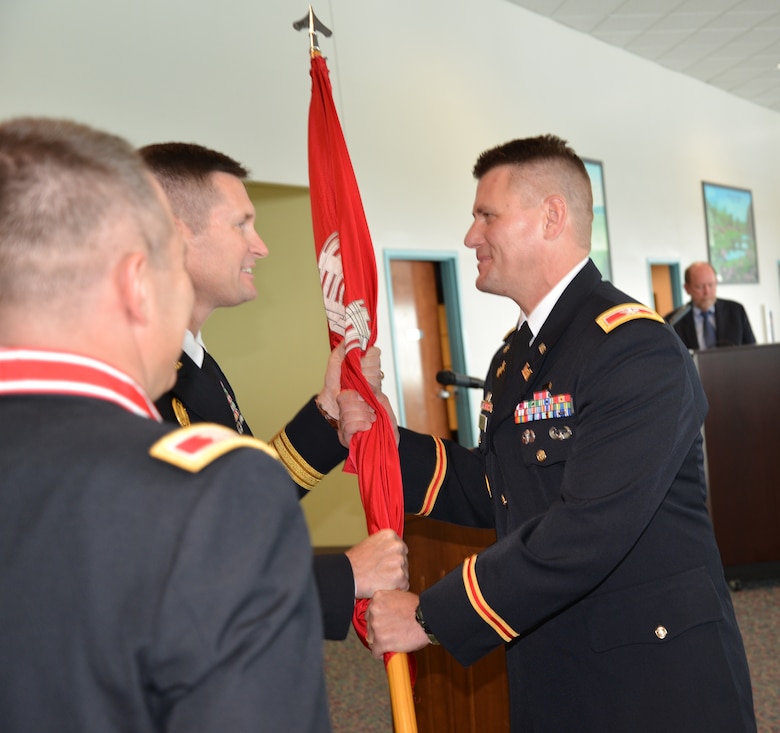 Incoming Mobile District Commander Col. Jon Chytka receives the Corps of Engineers Command Flag from South Atlantic Division Commander Brig. Gen. Donald Jackson during Mobile District's Change of Command Ceremony, which was held Aug. 1, 2013 in downtown Mobile, Ala. at the Alabama Cruise Terminal. The Change of Command tradition dates back to the Civil War and emphasizes the continuity of leadership and unit identity despite changes in individual authority from one another. The heart of the ceremony is the passing of the command flag - the symbol of the unit's identity - from the outgoing commander to incoming commander. Col. Chytka succeeded previous Mobile District Commander Col. Steven Roemhildt. Photo by Lance Davis, Mobile District Public Affairs Office.