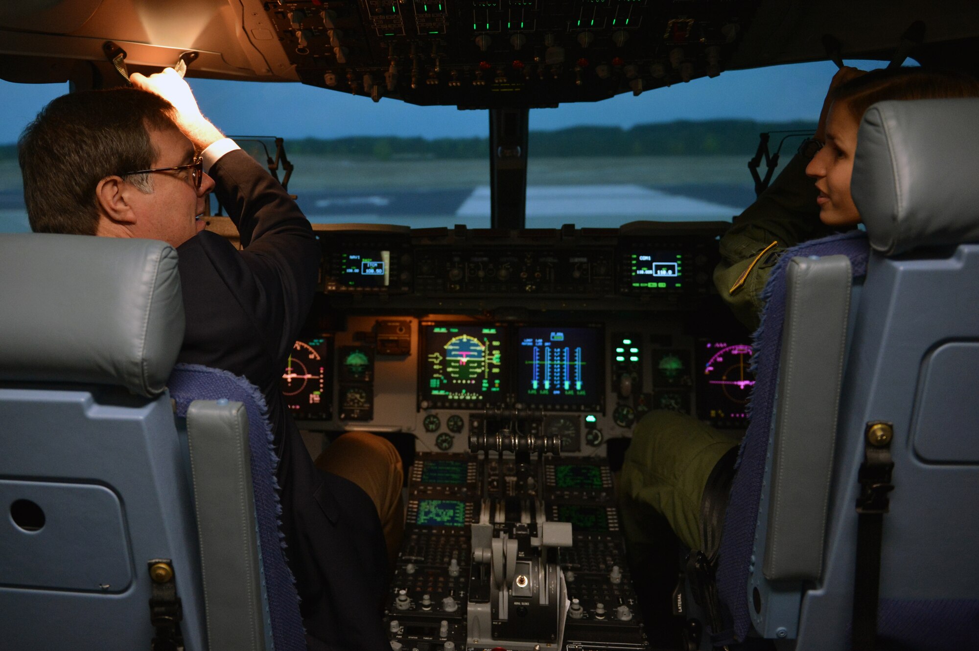 Capt. Laurie Needer shows Congressman Denny Heck how to adjust his seat in a C-17 Globemaster III flight simulator Aug. 14, 2013 at Joint Base Lewis-McChord, Wash. Congressman Heck took a simulated flight around McChord Field. (U.S. Air Force photo/Staff Sgt. Jason Truskowski)

