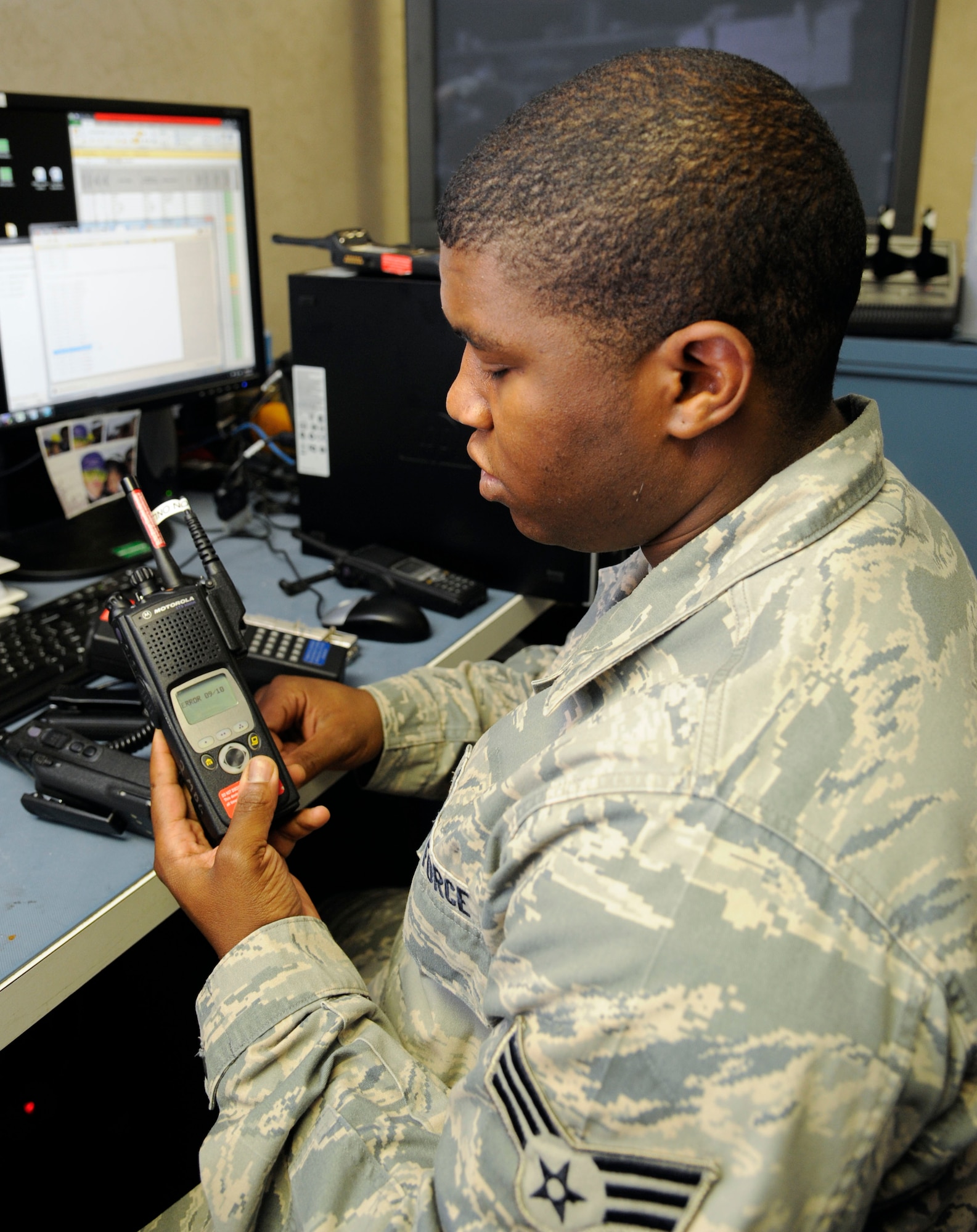 Senior Airman Darryl Elliott, 2nd Communications Squadron Client Systems Team client services technician, encrypts a radio handset on Barksdale Air Force Base, La., Aug. 14, 2013. To encrypt handsets, Elliott uses a device called a Key Variable Loader, which enable handsets to be loaded with encryption keys to allow secure communications. (U.S. Air Force photo/Airman 1st Class Andrew Moua)