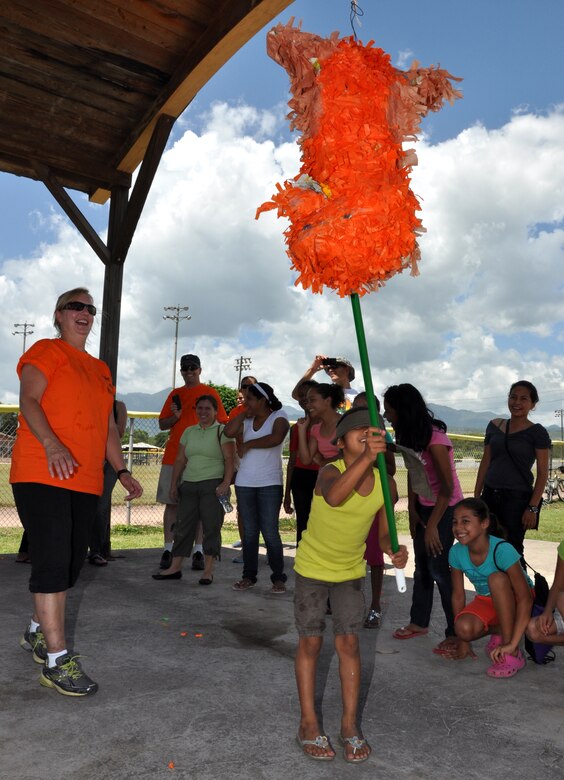 During an event here, hosted by the Medical Element called Fiesta Day, a young girl hits a piñata with a stick, as the other children wait in anticipation for the candy to fall Aug. 10, 2013. The JTF-Bravo’s MEDEL joined with “Kick for Nick,” a nonprofit organization, to hold a Fiesta Day, during the event, more than 75 girls from a local orphanage received more than 35 soccer balls donated by the organization, while also participating in other activities. (Photo released by U.S. Air Force Staff Sgt. Jarrod Chavana)