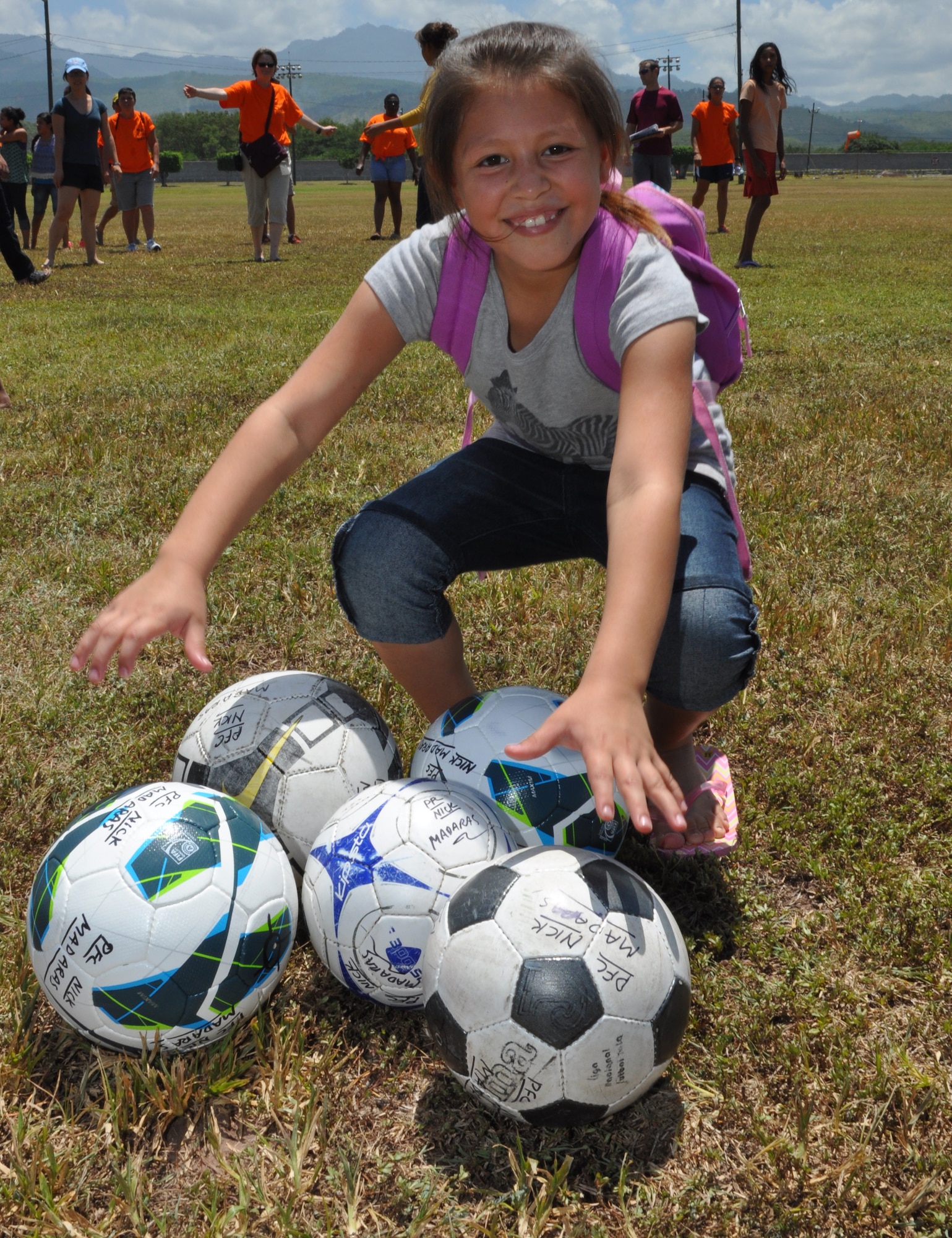 During an event here, hosted by the Medical Element called Fiesta Day, a young girl poses with soccer balls donated by “Kick for Nick” Aug. 10, 2013. The JTF-Bravo’s MEDEL joined with “Kick for Nick,” a nonprofit organization, to hold a Fiesta Day, during the event, more than 75 girls from a local orphanage received more than 35 soccer balls donated by the organization, while also participating in other activities. (Photo  released by U.S. Air Force Staff Sgt. Jarrod Chavana)