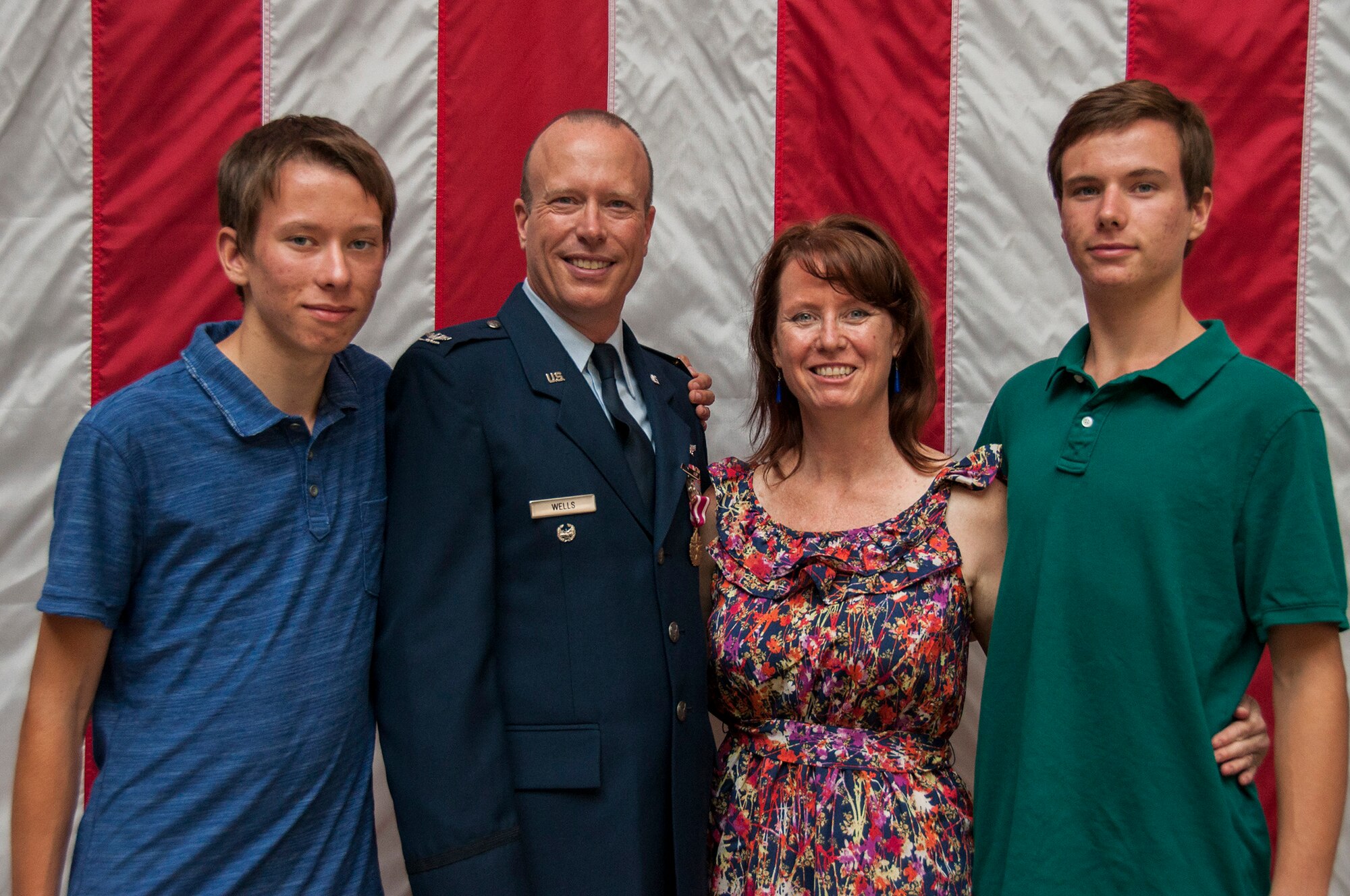 TRAVIS AIR FORCE BASE, Calif. -- Col. Craig Wells, 349th Mission Support Group, receives the meritorious service medal and pins on the rank of colonel during a pinning-on ceremony held here at Travis Air Force Base, Calif. on August 10, 2013. ( U.S Air Force photo / Senior Airman Amelia Leonard) 