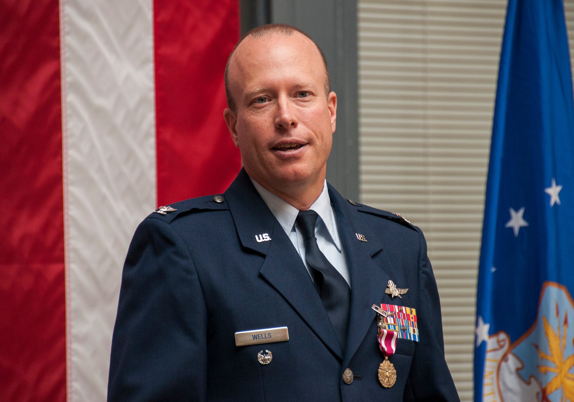 TRAVIS AIR FORCE BASE, Calif. -- Col. Craig Wells, 349th Mission Support Group, receives the meritorious service medal and pins on the rank of colonel during a pinning-on ceremony held here at Travis Air Force Base, Calif. on August 10, 2013. ( U.S Air Force photo / Senior Airman Amelia Leonard) 