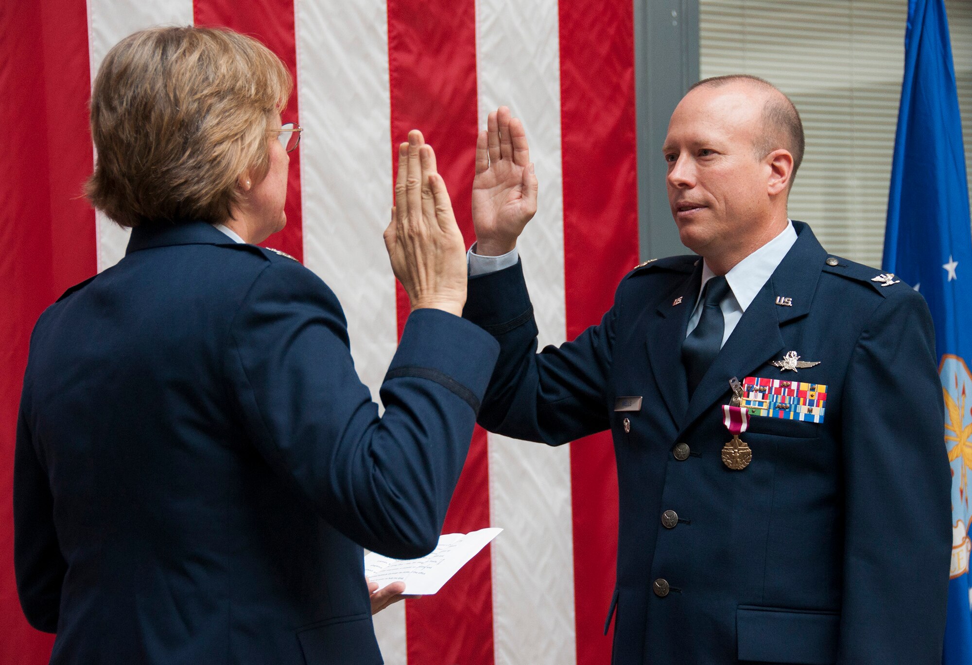 TRAVIS AIR FORCE BASE, Calif. -- Col. Craig Wells, 349th Mission Support Group, receives the meritorious service medal and pins on the rank of colonel during a pinning-on ceremony held here at Travis Air Force Base, Calif. on August 10, 2013. ( U.S Air Force photo / Senior Airman Amelia Leonard) 