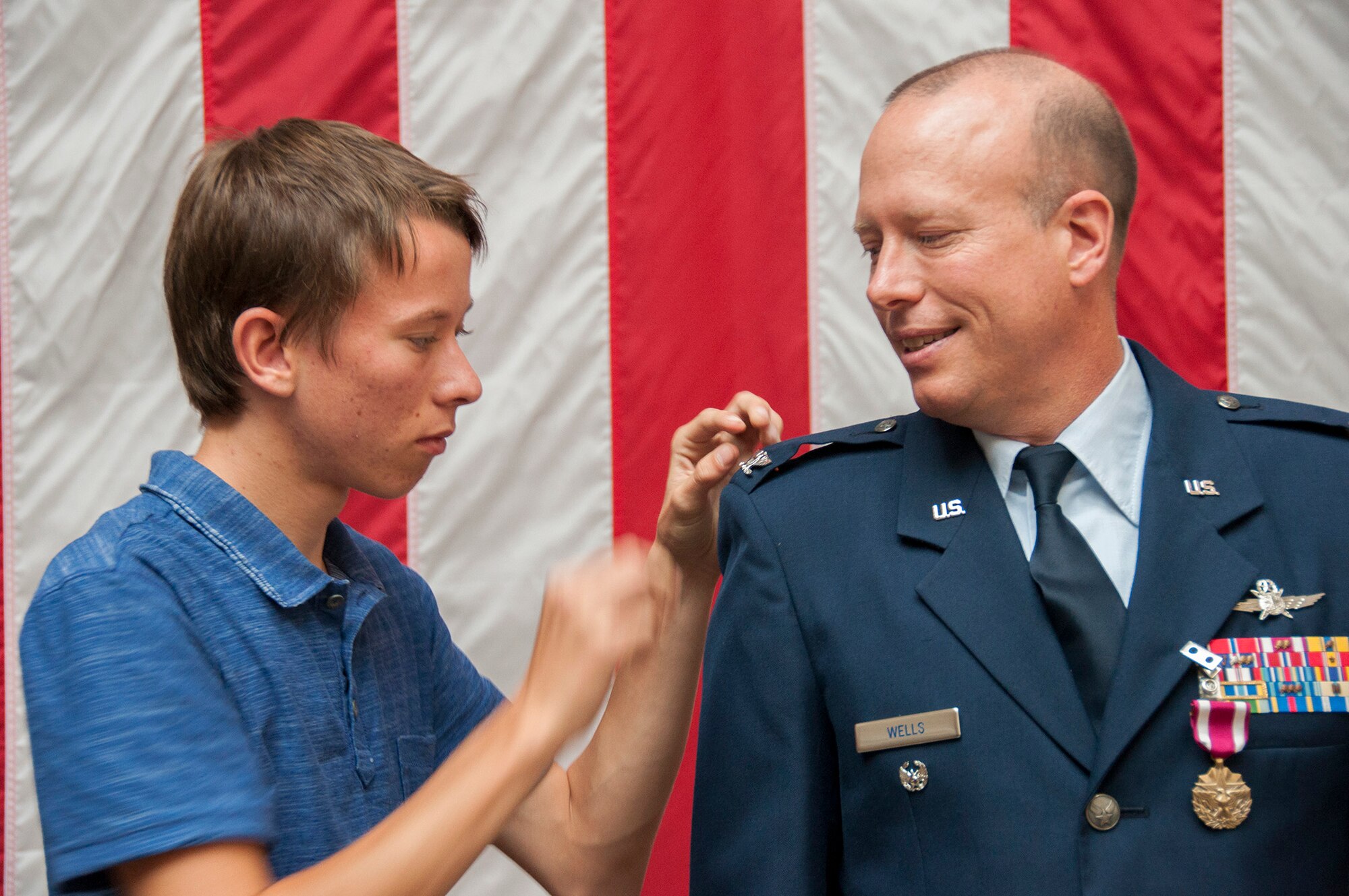 TRAVIS AIR FORCE BASE, Calif. -- Col. Craig Wells, 349th Mission Support Group, receives the meritorious service medal and pins on the rank of colonel during a pinning-on ceremony held here at Travis Air Force Base, Calif. on August 10, 2013. ( U.S Air Force photo / Senior Airman Amelia Leonard) 