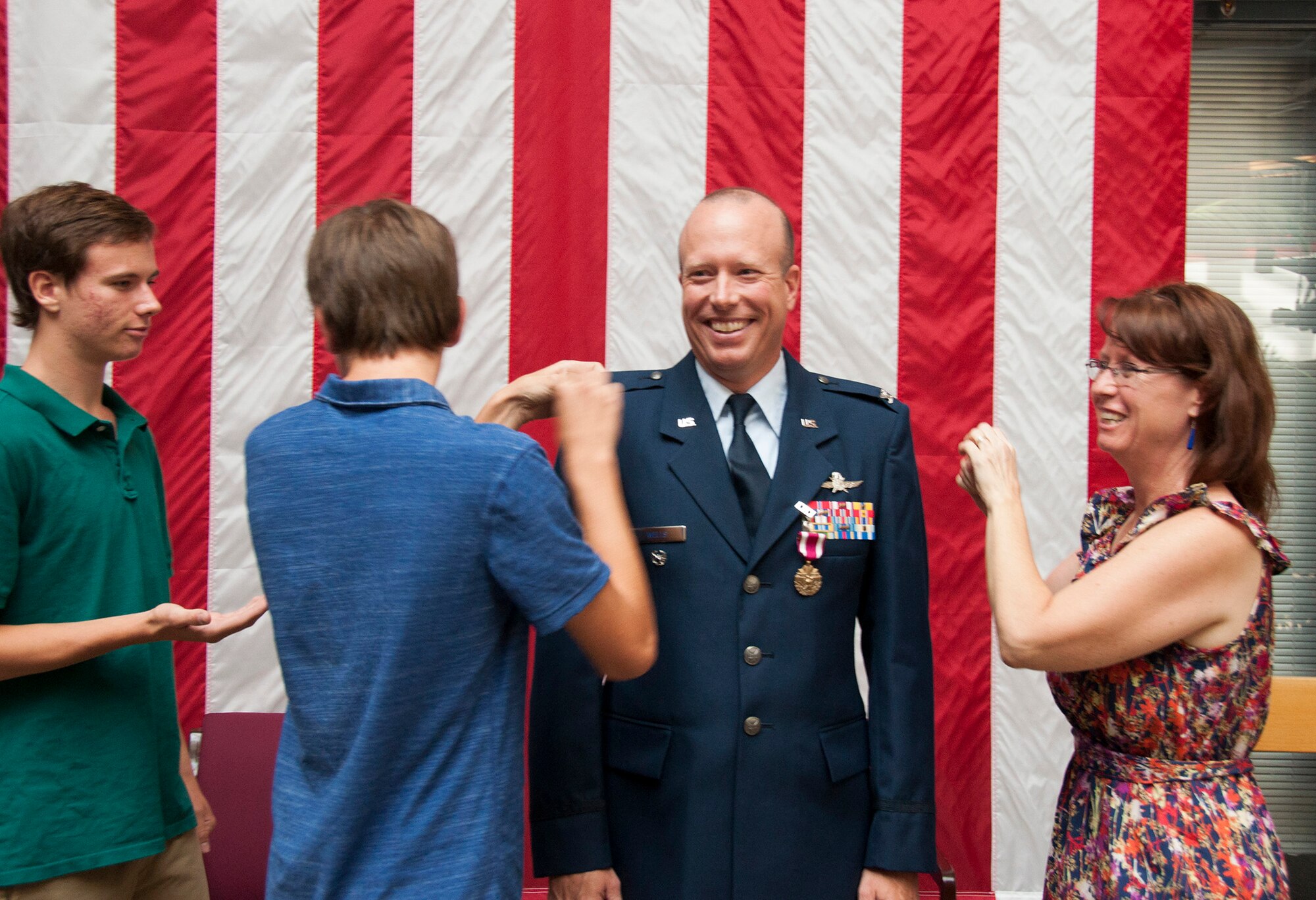 TRAVIS AIR FORCE BASE, Calif. -- Col. Craig Wells, 349th Mission Support Group, receives the meritorious service medal and pins on the rank of colonel during a pinning-on ceremony held here at Travis Air Force Base, Calif. on August 10, 2013. ( U.S Air Force photo / Senior Airman Amelia Leonard) 