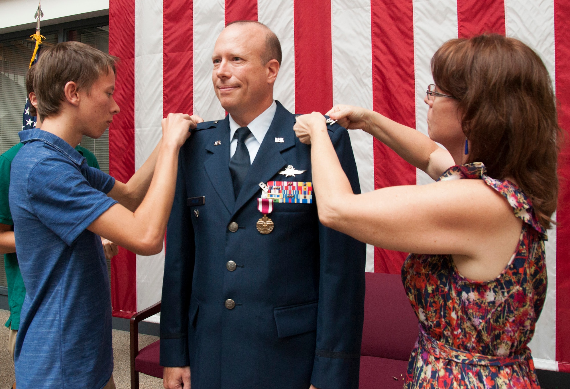 TRAVIS AIR FORCE BASE, Calif. -- Col. Craig Wells, 349th Mission Support Group, receives the meritorious service medal and pins on the rank of colonel during a pinning-on ceremony held here at Travis Air Force Base, Calif. on August 10, 2013. ( U.S Air Force photo / Senior Airman Amelia Leonard) 