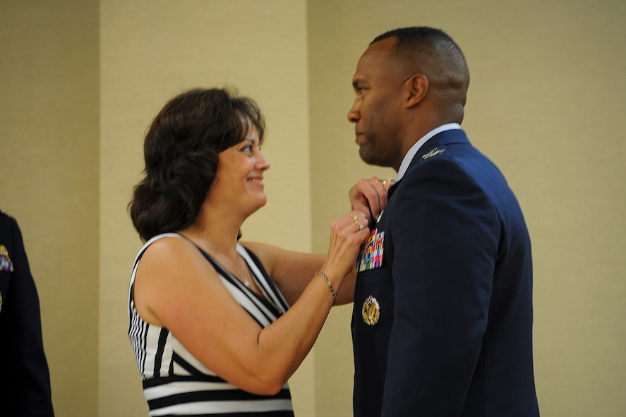 U.S. Air Force Col. Alvis Headen III, 23d Medical Group commander, receives a retirement pin from his wife, Carla, during a retirement ceremony Aug. 9, 2013, at Moody Air Force Base, Ga. Headen and his wife have been married for more than 28 years. (U.S. Air Force photo by Airman Alexis A. Grotz/Released)  