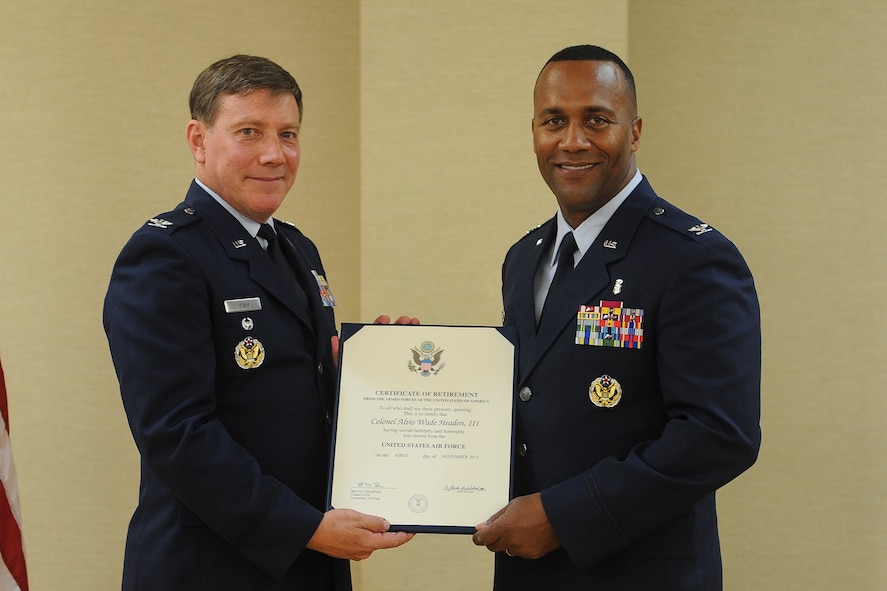 U.S. Air Force Col. Alvis Headen III (right), 23d Medical Group commander, receives a retirement certificate from retired Col. Larry Kimm during a retirement ceremony Aug. 9, 2013, at Moody Air Force Base, Ga. Headen knew Kimm for 24 years of his 28-year military career. (U.S. Air Force photo by Airman Alexis A. Grotz/Released) 