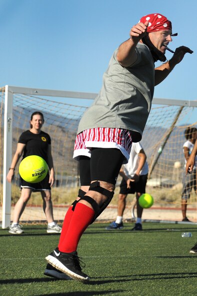 LAS VEGAS, Nev. -- Chief Master Sgt. Butch Brien, 432nd Wing/432nd Air Expeditionary Wing command chief, dodges a ball during the 432nd Wing/ 432nd Air Expeditionary Wing’s Comprehensive Airmen Fitness Day dodge ball tournament, Aug. 9, 2013. The day’s event was to provide a fun and different approach to help strengthen Airmen’s understanding and application of CAF through interactive training and team-building activities. (U.S. Air Force photo by Staff Sgt. N.B./released)